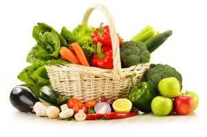 Composition with raw vegetables in wicker basket isolated on white